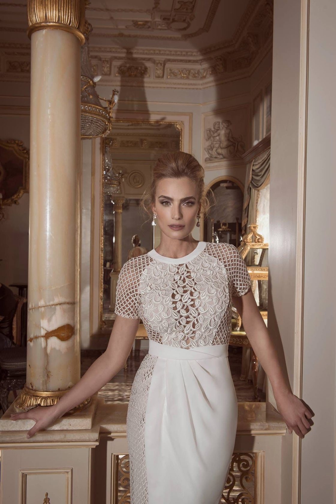 A Yaki Ravid gown, onyx-columned palace room
